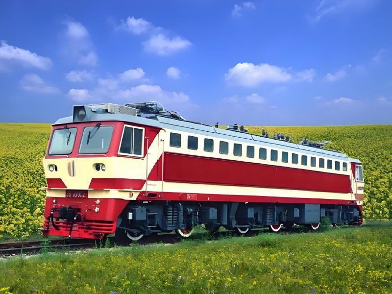 Electric locomotive pulling freight cars on railway tracks